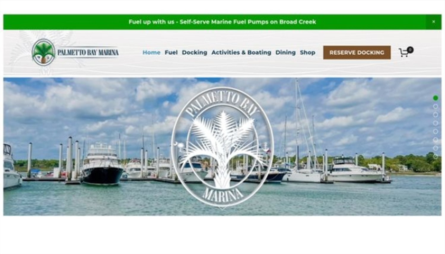 Marina with boats docked on the water under a partly cloudy sky, featuring a large logo for Palmetto Bay Marine with palm trees in the center.
