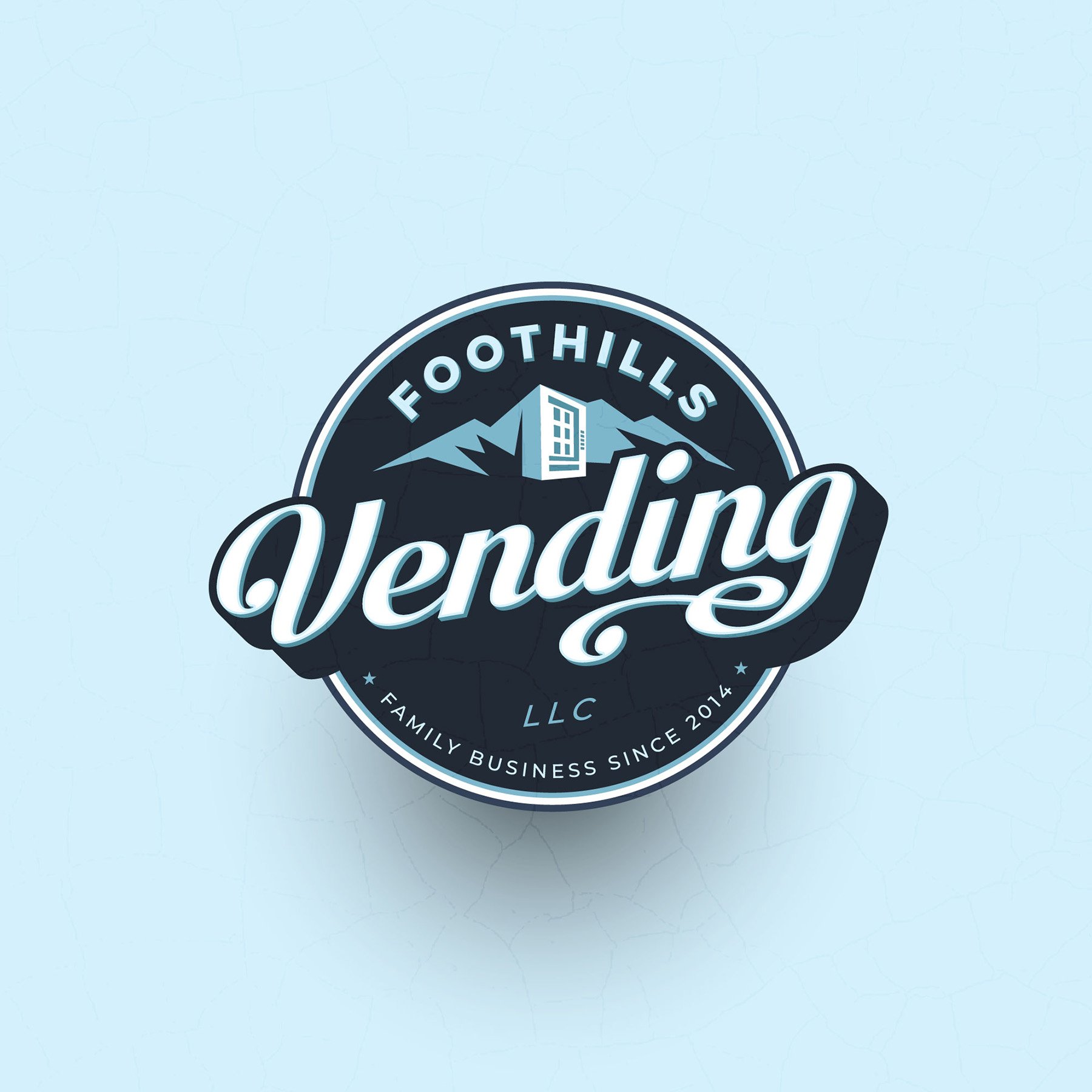A circular logo with mountains, a building, and a snowball. The text around the logo reads "Foothills Lodging LLC" and "Family Business Since 2014".