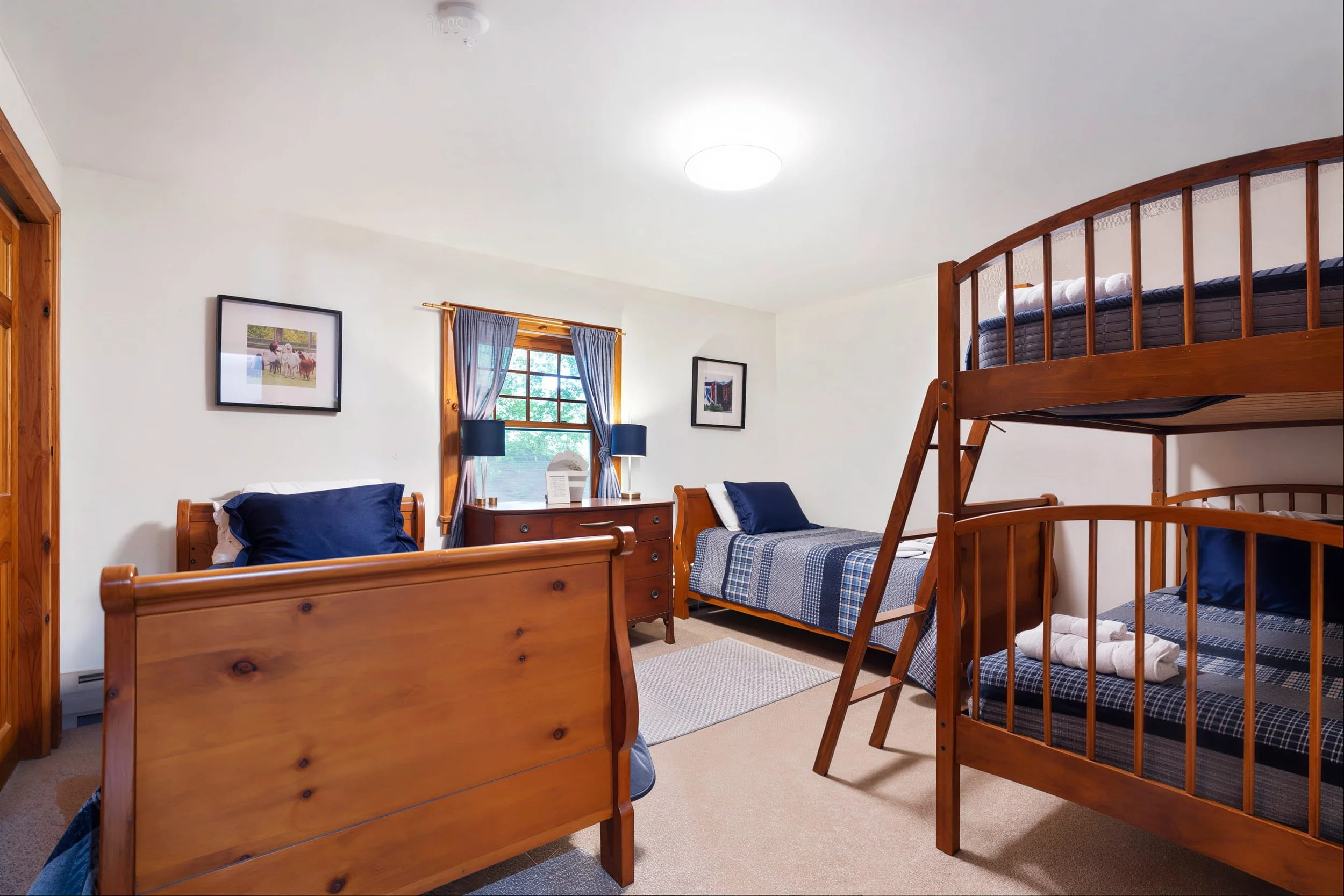 Dorm-Style Accommodations in Main House. (Note that while the photo shows four beds, this room currently the bunk beds with one Queen bed. )