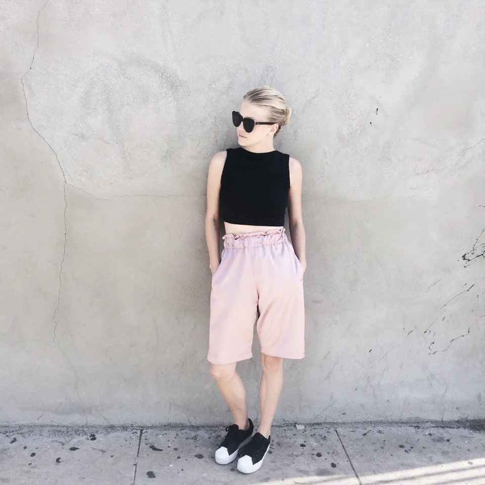 Crop top by Win Win shop , sunnies by Komono (via Freshlabels.cz ), shorts by Odivi and sneakers by Adidas .