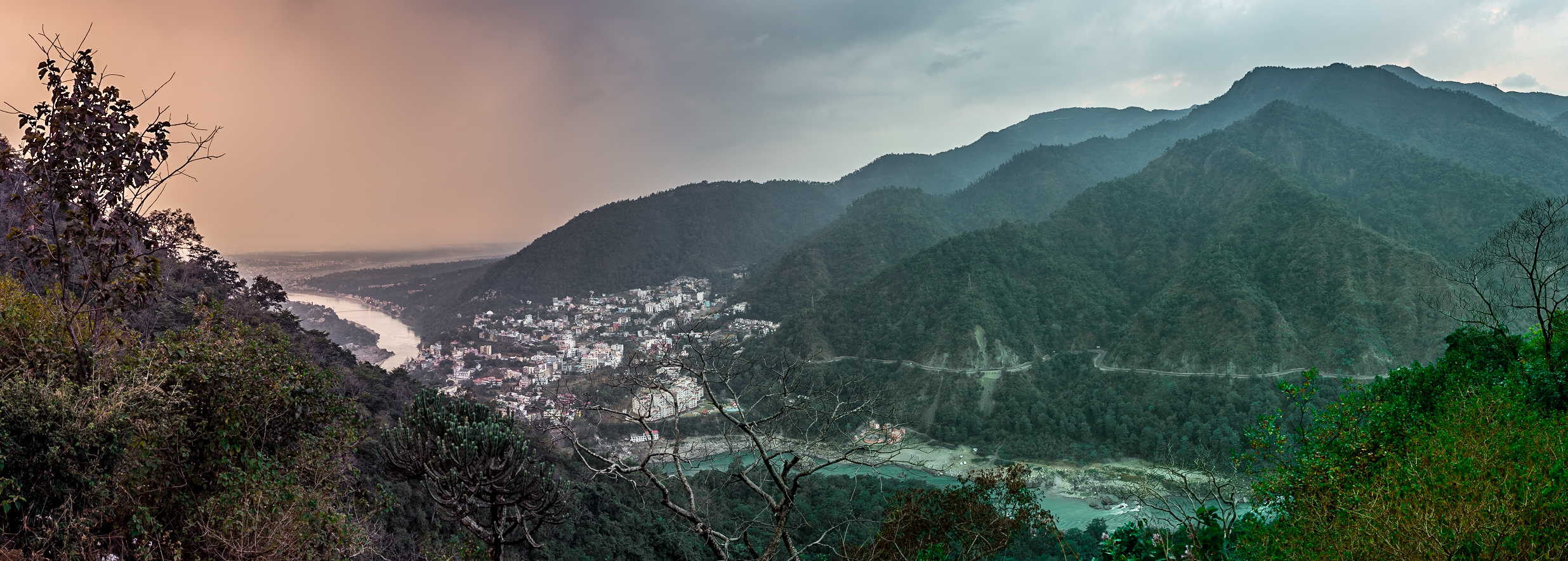 View of the Tapovan neighborhood of Rishikesh and the Ganges snaking through the foothills of the Himalayas.