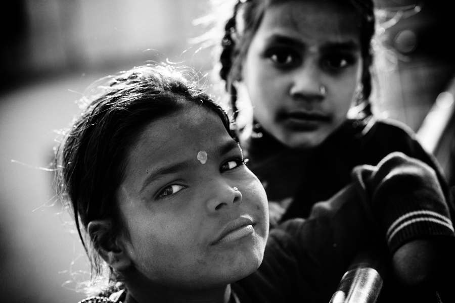 The girl in the previous photograph and her friend -- also an Aarti plate saleswoman. Children are often tasked with the job of selling Aarti plates to tourists. They wonder the ghats -- steps leading down to the Ganges -- with trays of Aarti plates, which Hindus release as oblations in the Ganges.
