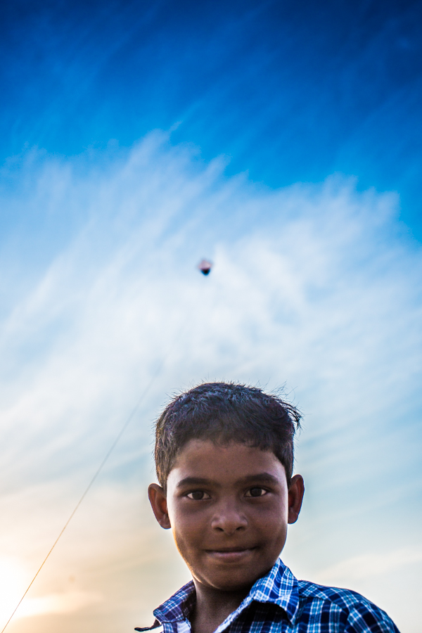 Boy flying kite at the Marina Beach in Chennai.