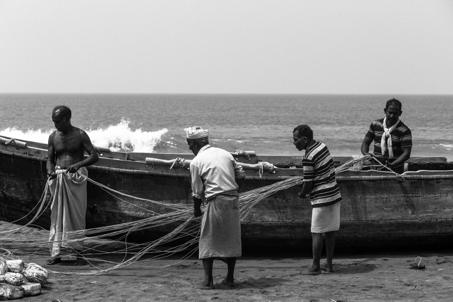 Varkala fisherman folding their nets.