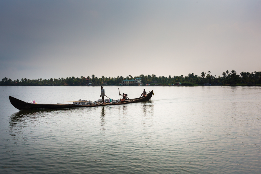 Villagers transporting rocks for construction through the backwaters near Alleppey.