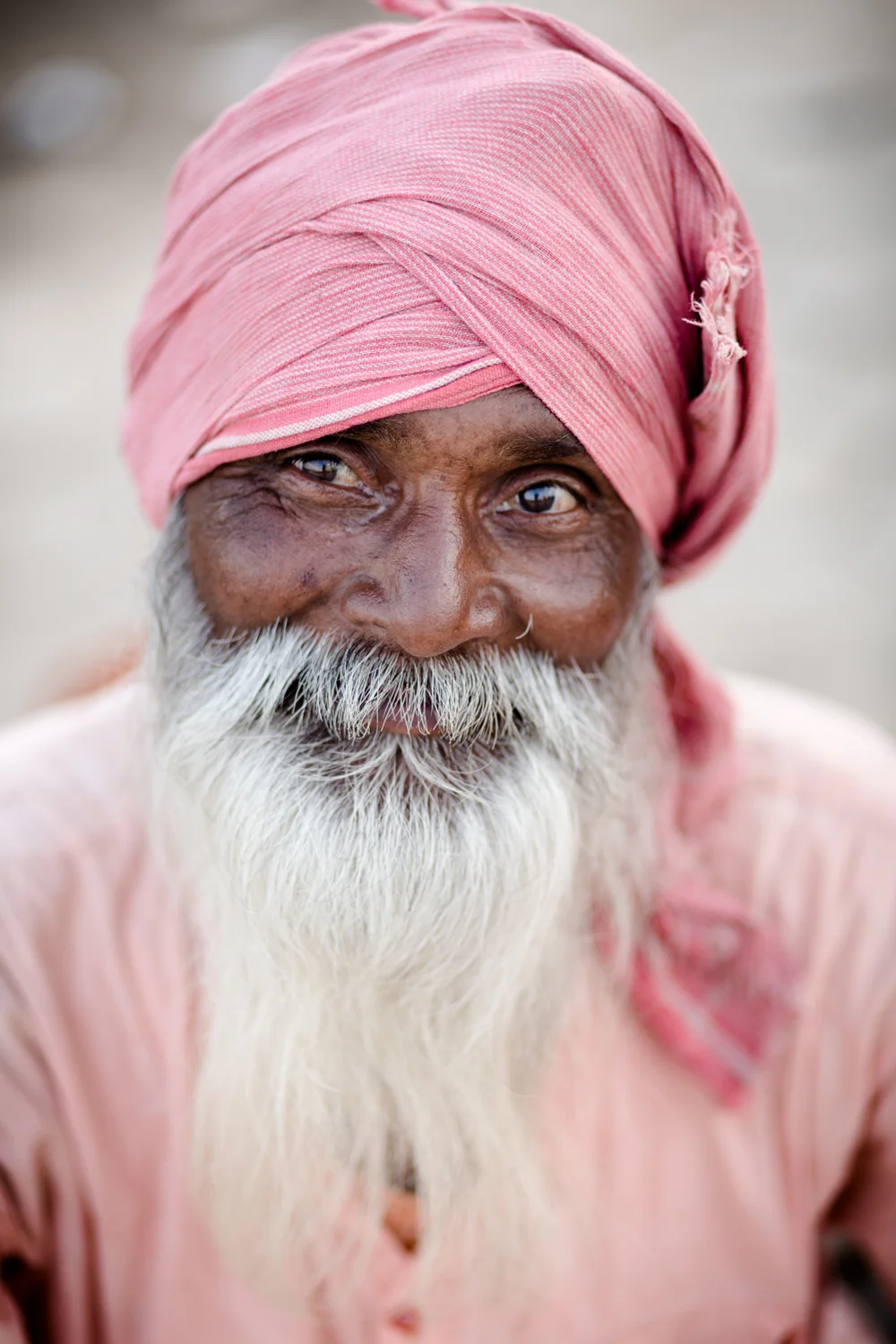A Sadhu sitting by the Shipra River. Kumbh Mela provides an opportunity for Sadhus (Hindu monks) to interact with lay people. 