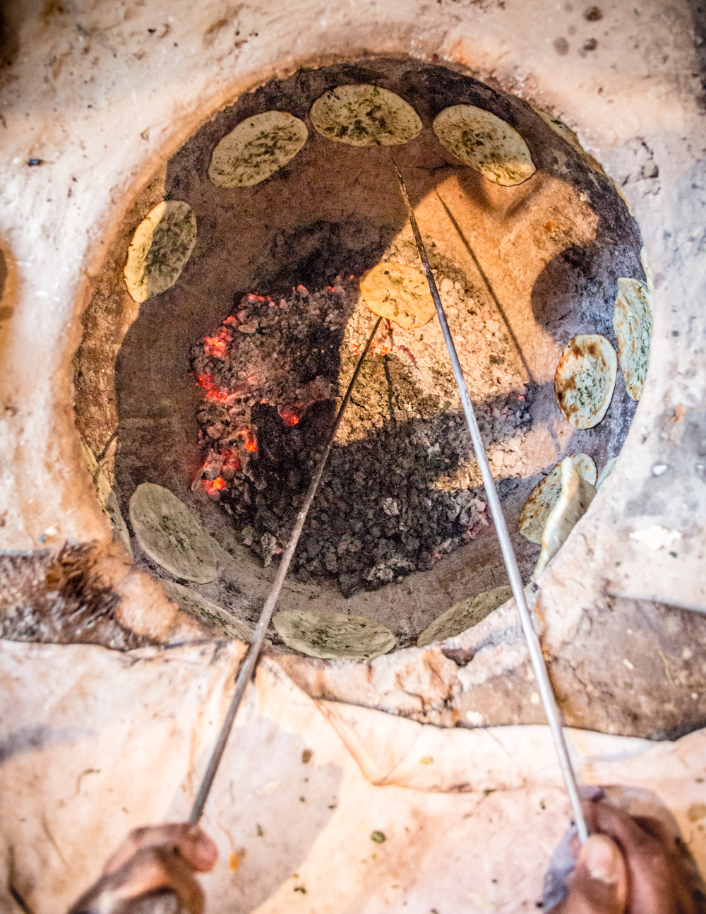 Kulcha being prepared in a tandoori oven at Dhashan Kulchewala . 