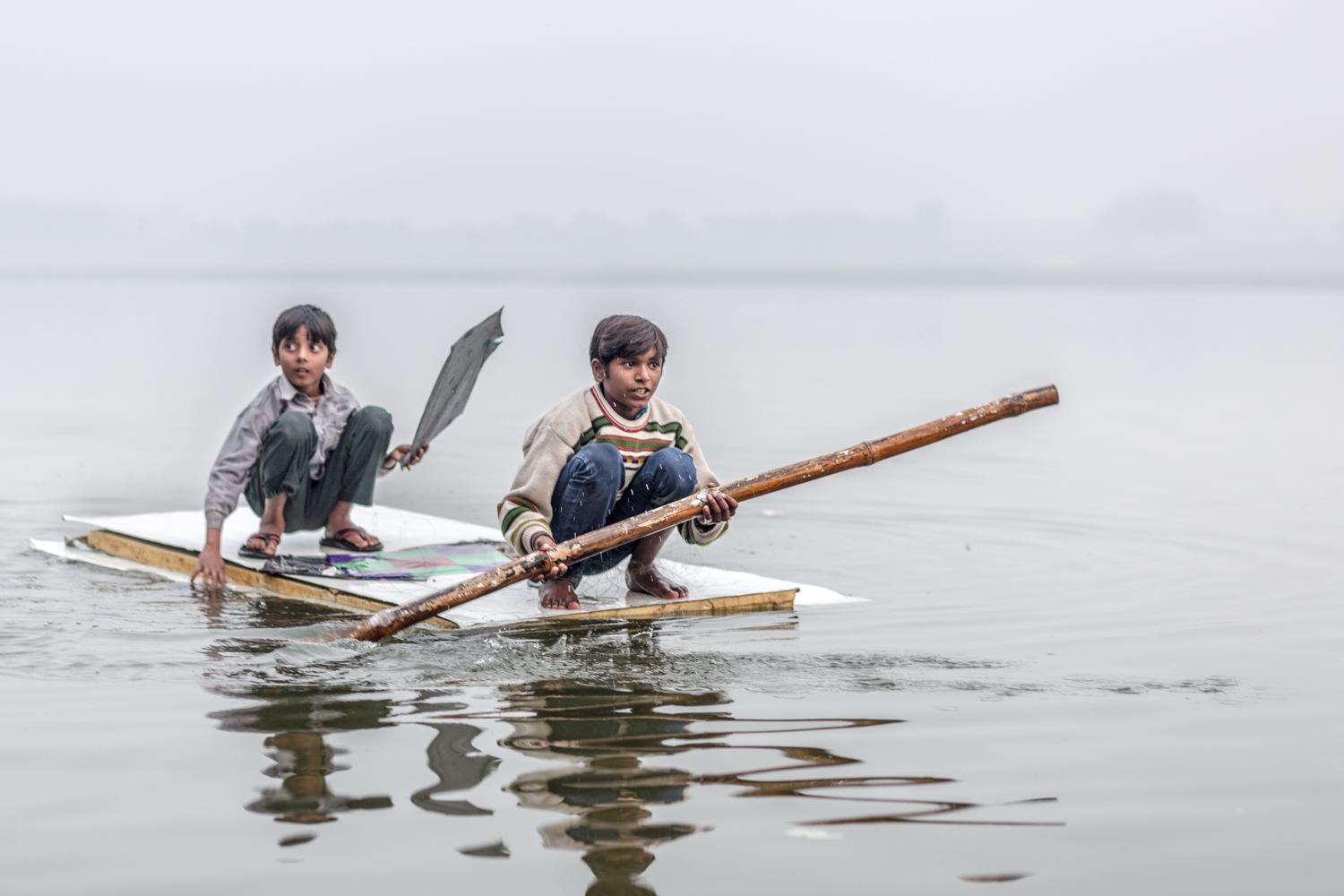 Two boys retrieving their kite from the Ganges. 