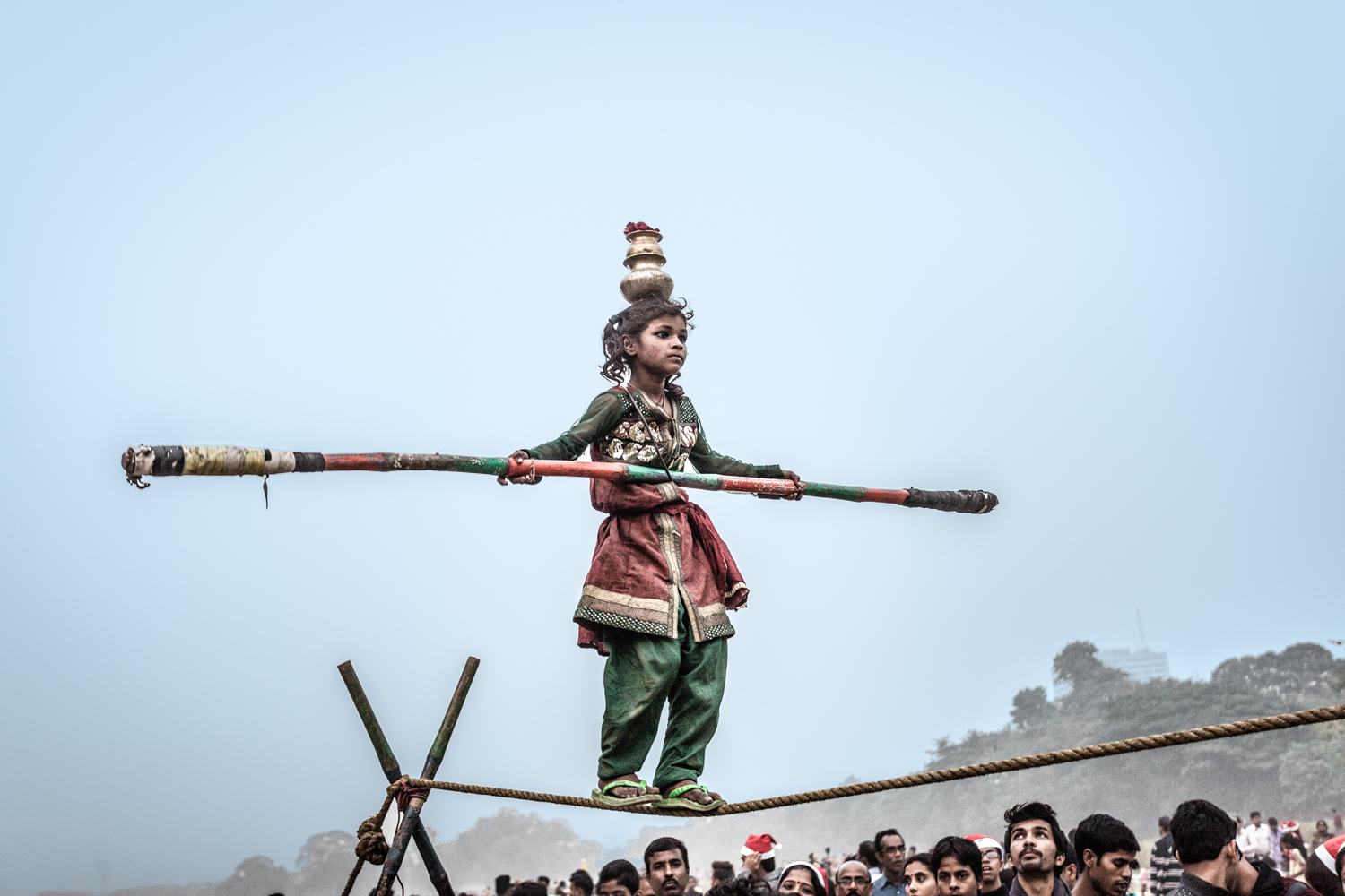 In the Maiden, a young girl performs acrobatic feats for alms.