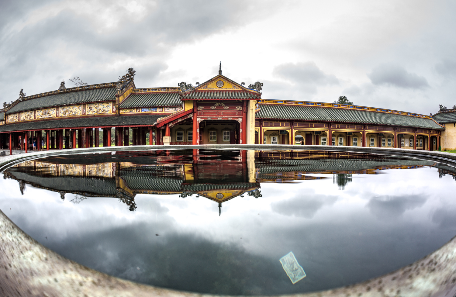 Imperial Citadel in Hue, the national capital from 1802-1945 under the Nguyen Dynasty. Sections of the citadel were damaged during the Vietnam war. Visitors deposit cash into the water basins for good luck. 