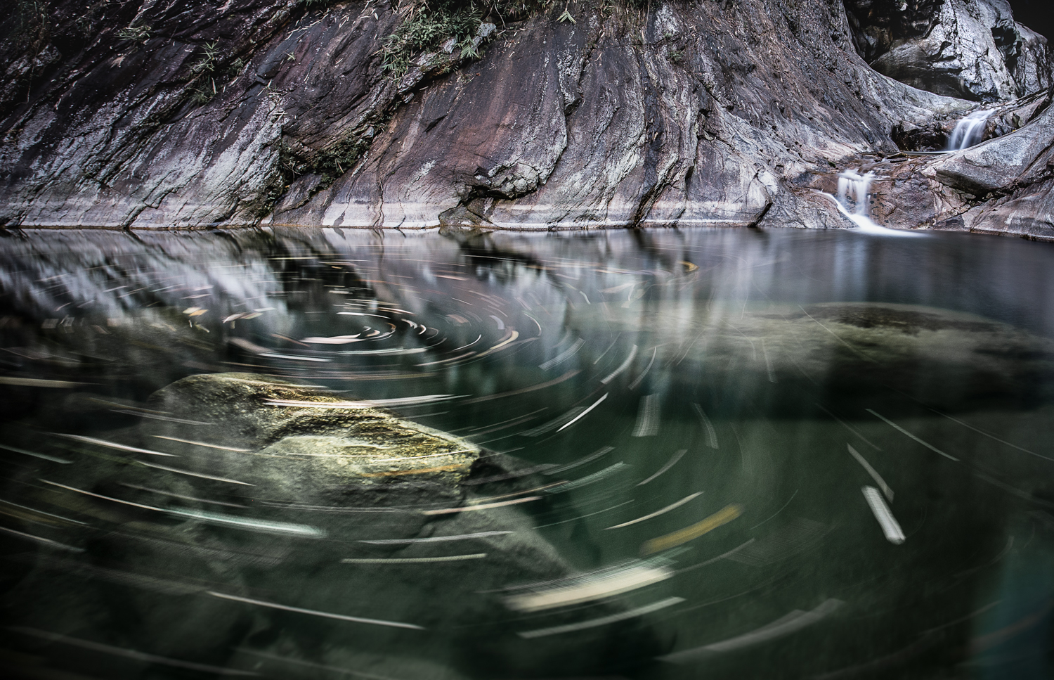 Leaves swirl in a lake near the China border in Ha Giang Province, Vietnam.