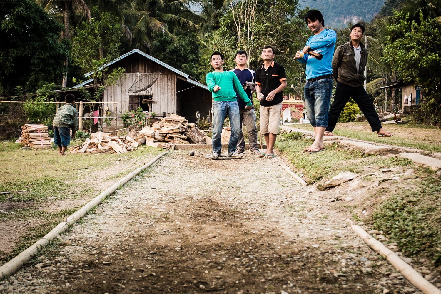 After 4 P.M. the local men of Muang Ngoy are more concerned with drinking beer over rounds of pétanque (a form of a form of boules) than making money of the tourists.