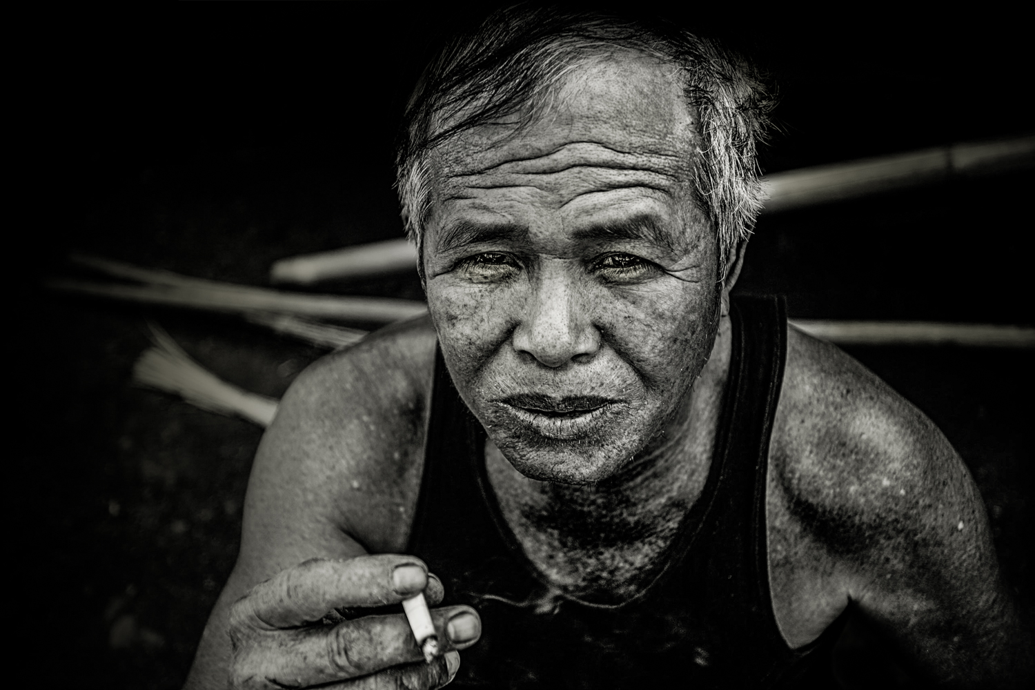 Craftsman taking a break from making wicker chairs in a village near Muang Ngoy. 