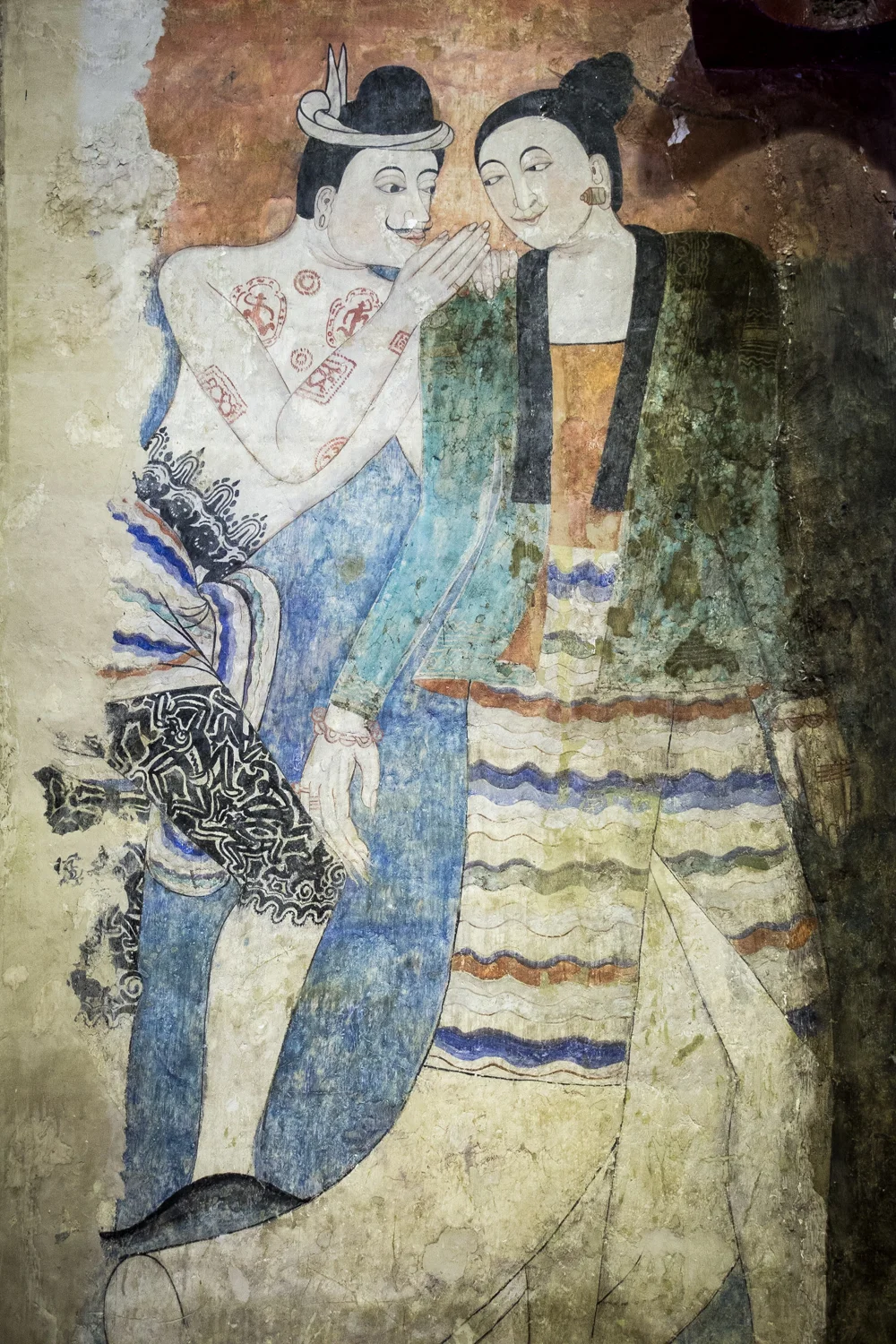  Thai Lü artist, Thit Buaphan, brazenly painted himself flirting with a women among his famed murals in Wat Phumin. 
