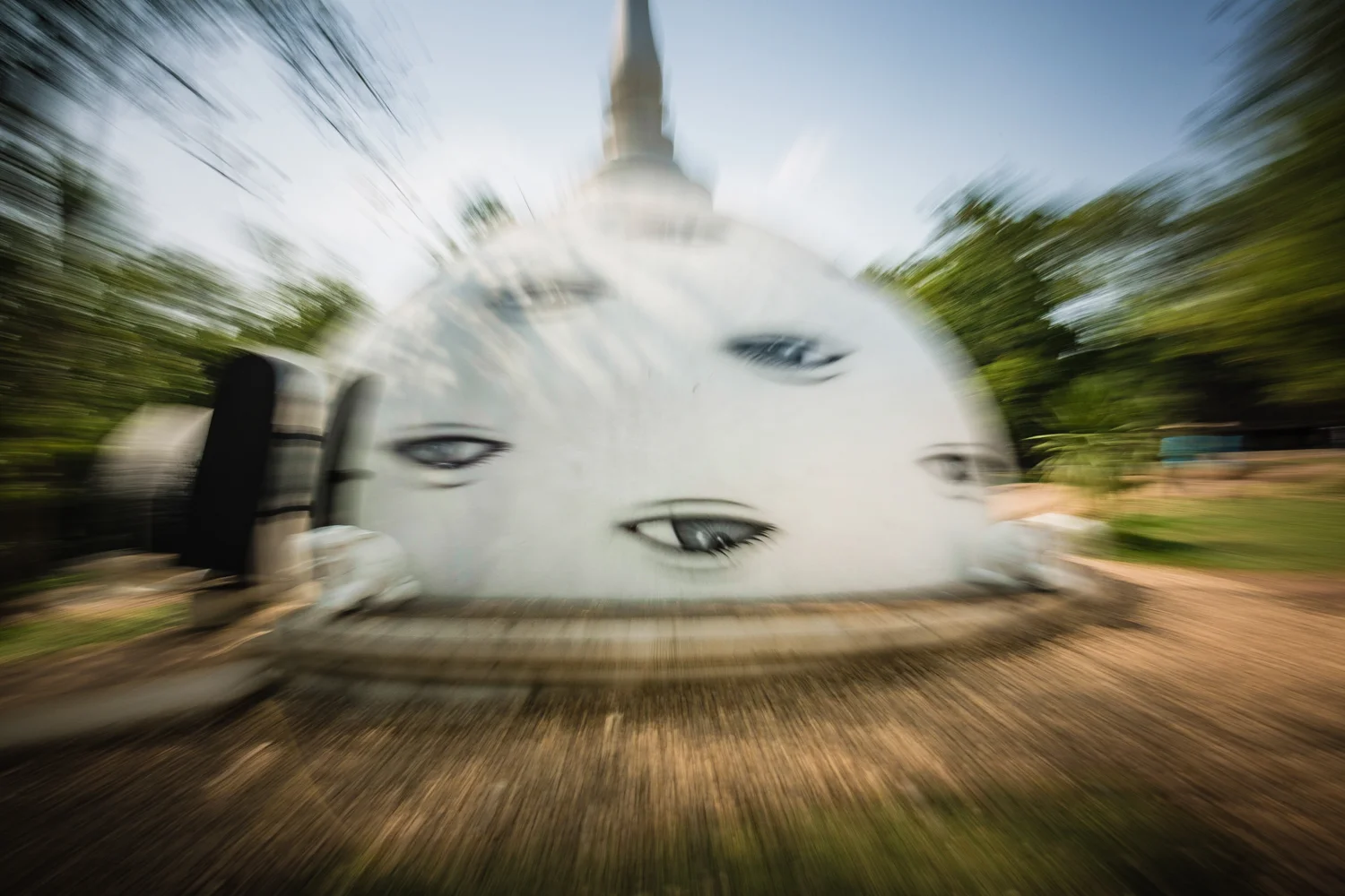 Breast-shaped building covered with eyes. 