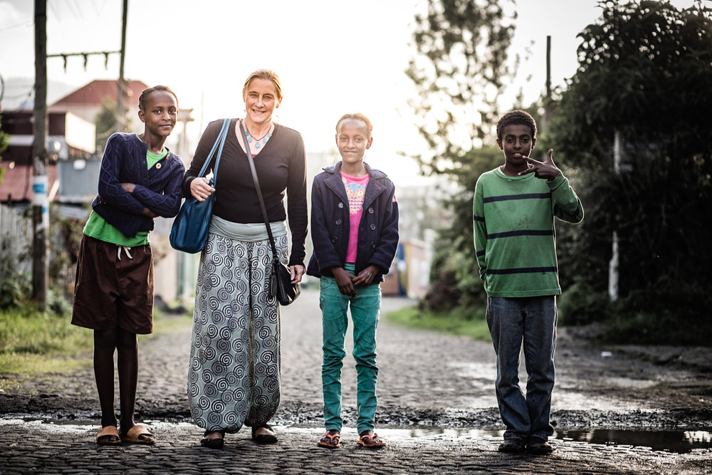  Claudia with a few of the Origins Homes kids near their home.&nbsp; 