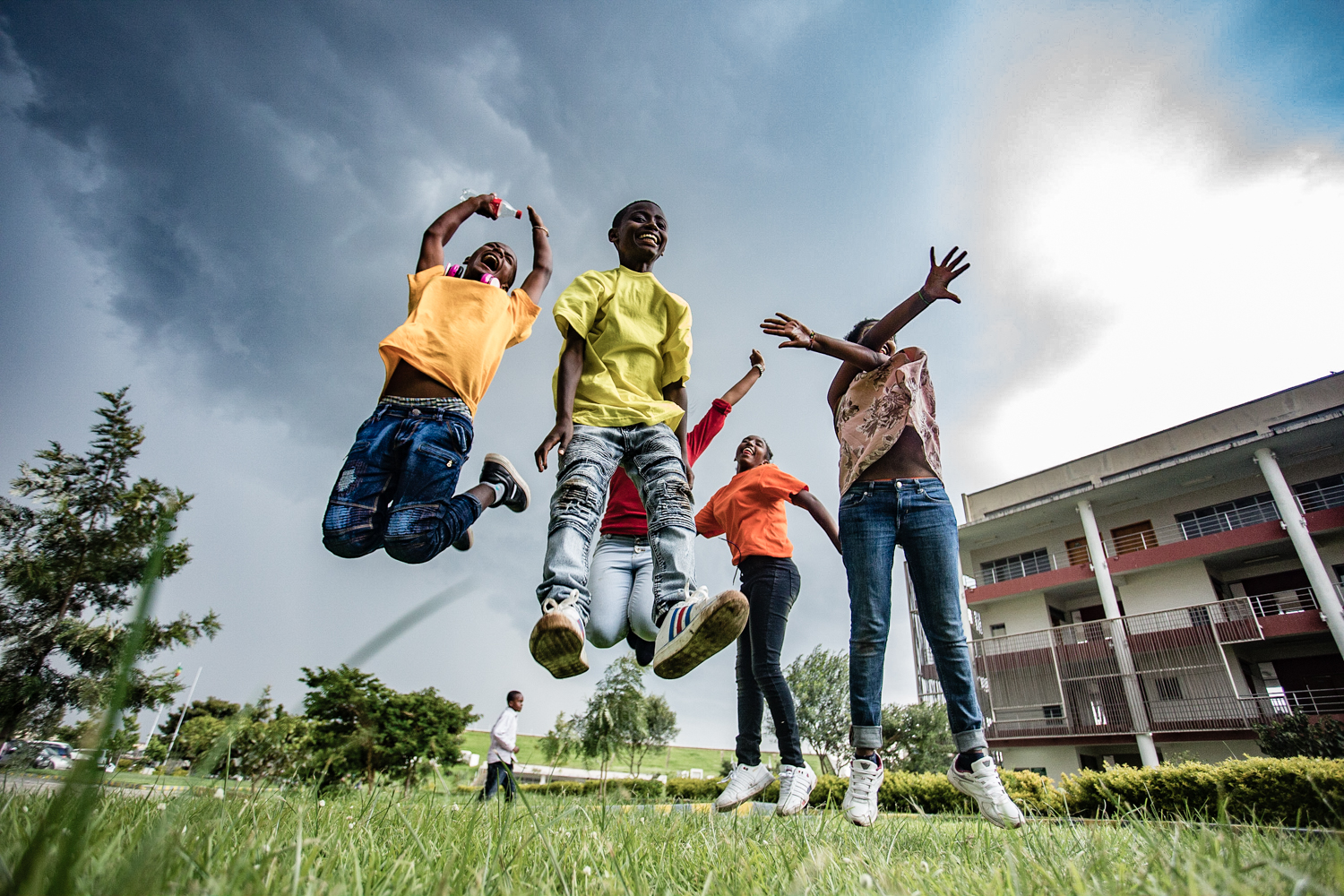 Origins Homes kids (really young adults!) enjoying their fleeting moments outside before the diurnal summer rain. 
