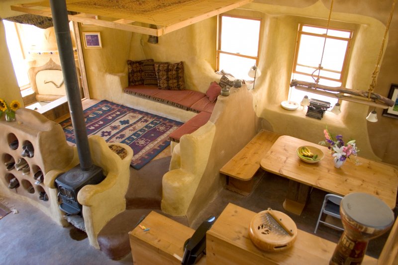 Raised Living Room with storage underneath earthen floor, earthen plastered Strawbale walls.jpg