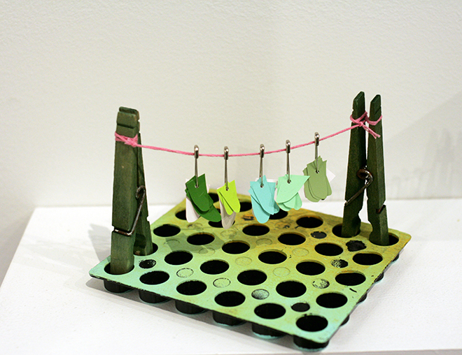THIS IS A STORY ABOUT THE BREEZE Glue stick container, Coloraid paper, thread, clothespins, paint 2014 2.5'' x 3'' x 3''