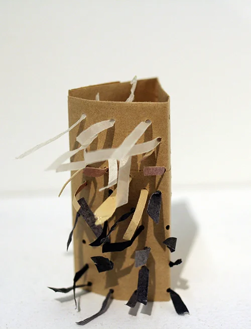 A STORY TOLD IN ONE DIRECTION Paper bag, paper scraps, brads 2014 2.5'' x 2.5'' x 1.5''