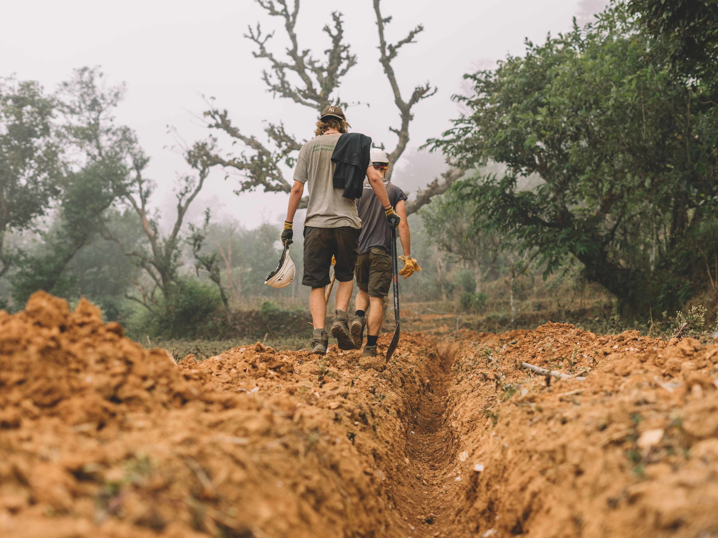 Seb and Harry walk along the 2km pipeline they help dig.