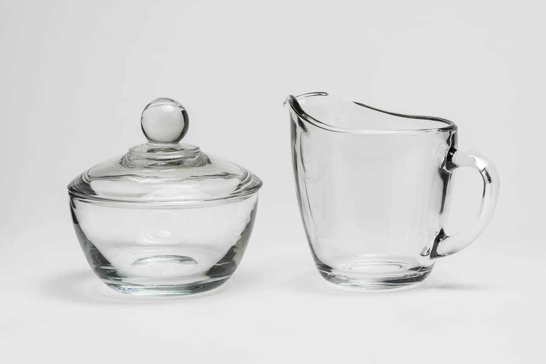 Clear Sugar and Creamer 8 oz.Height 4" Width 4" and 5" including handle $1.30/set