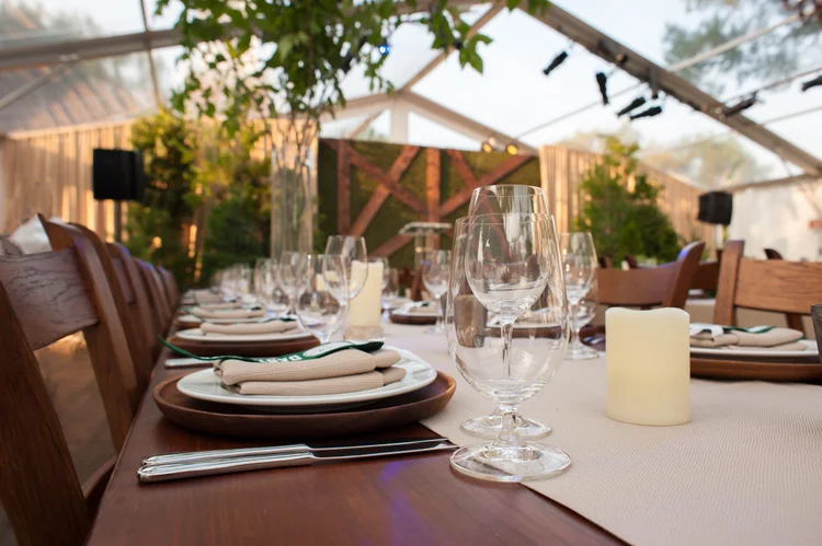 Place settings under a clear top event tent in Hanover New Hampshire