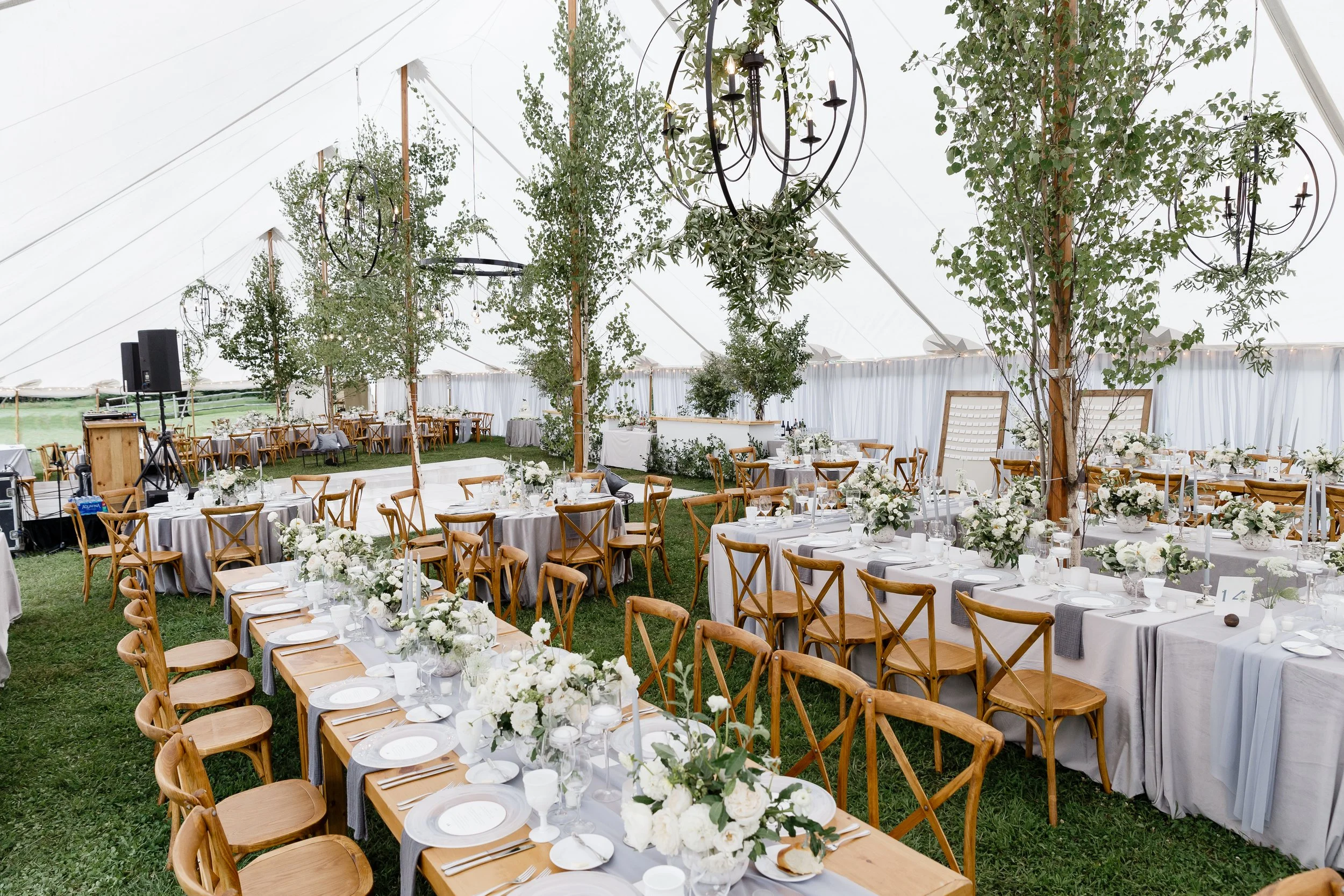 Full wedding tent package in Vermont featuring a sailcloth tent, reception tables, and crossback chairs.
