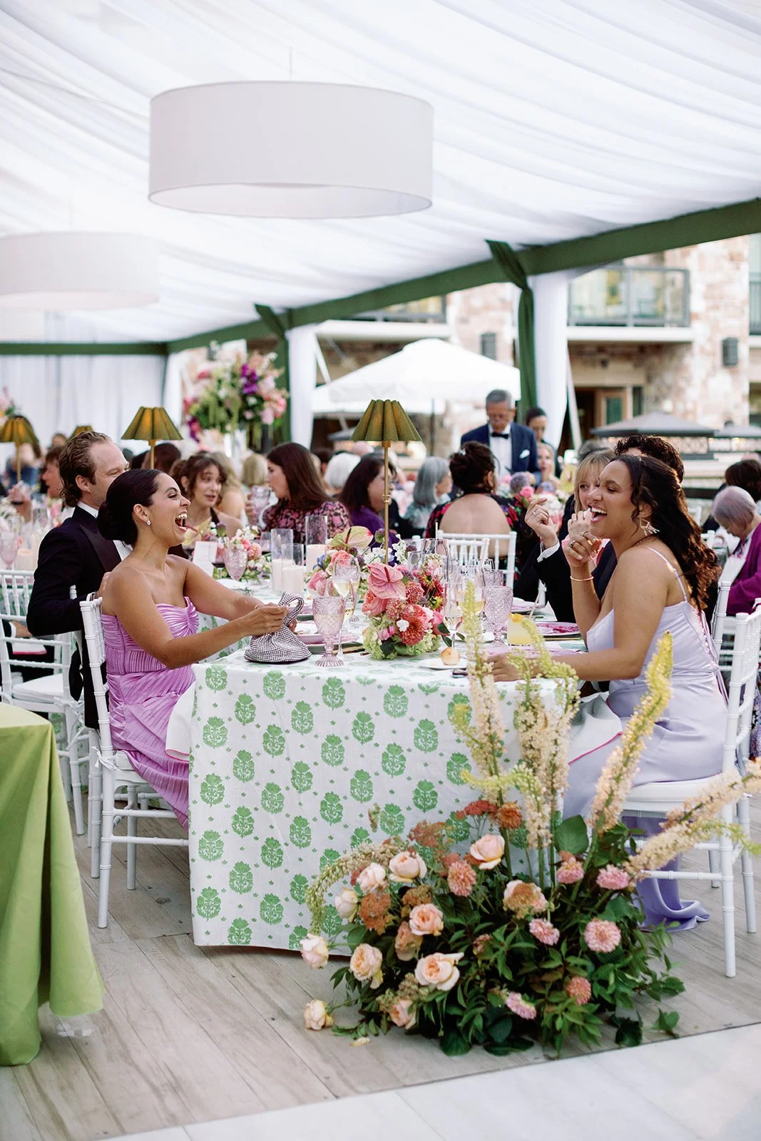 Wedding guests enjoying dinner at a beautifully designed reception at The St. Regis Deer Valley in Park City, Utah.