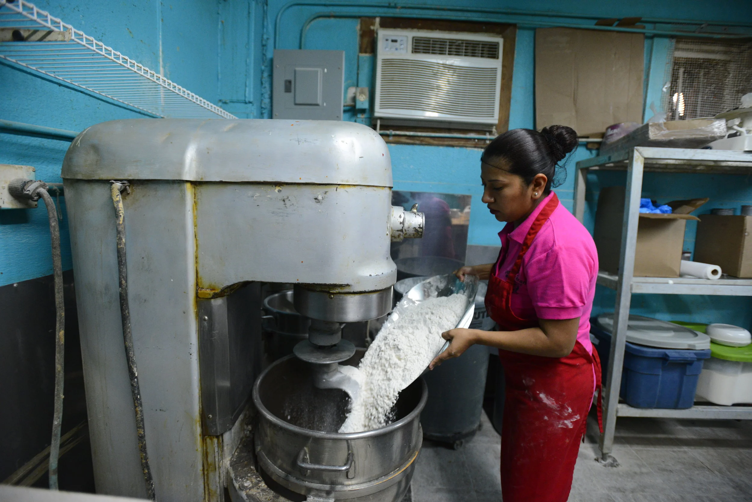  Lulu De La Garza pours ingredients into a mixing bowl at her bakery in Clute on Tuesday, Jan. 9, 2017. Ingredients must be correct, or the flavor will be off. 