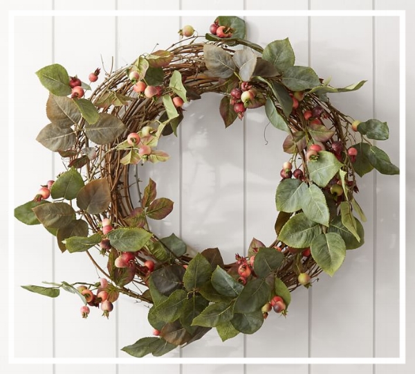 Add a wreath to the front door to welcome guests! This 'Rosehips Wreath' from Pottery Barn is simple and elegant