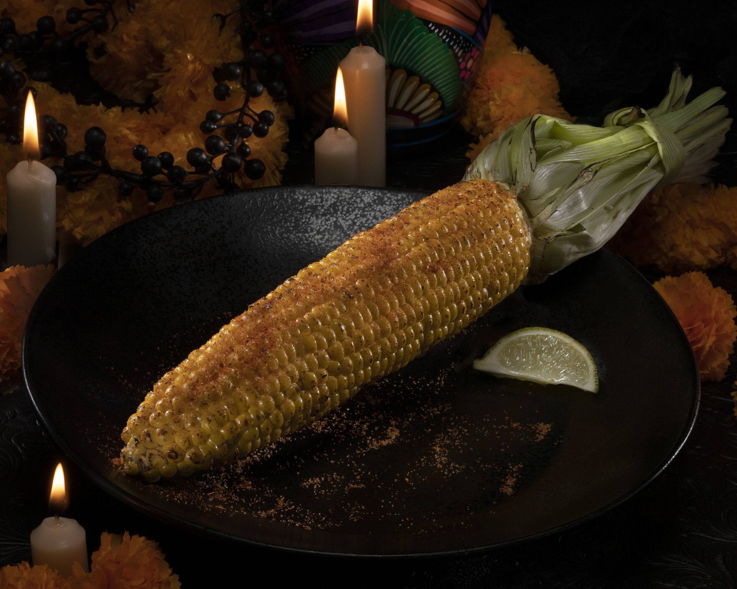Grilled Elote Corn brushed with a lime butter and topped with spices