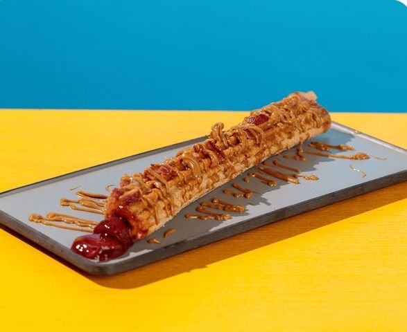 Cinnamon Sugar Churro stuffed with Jelly, with a Peanut Butter Drizzle, and Bacon Bits