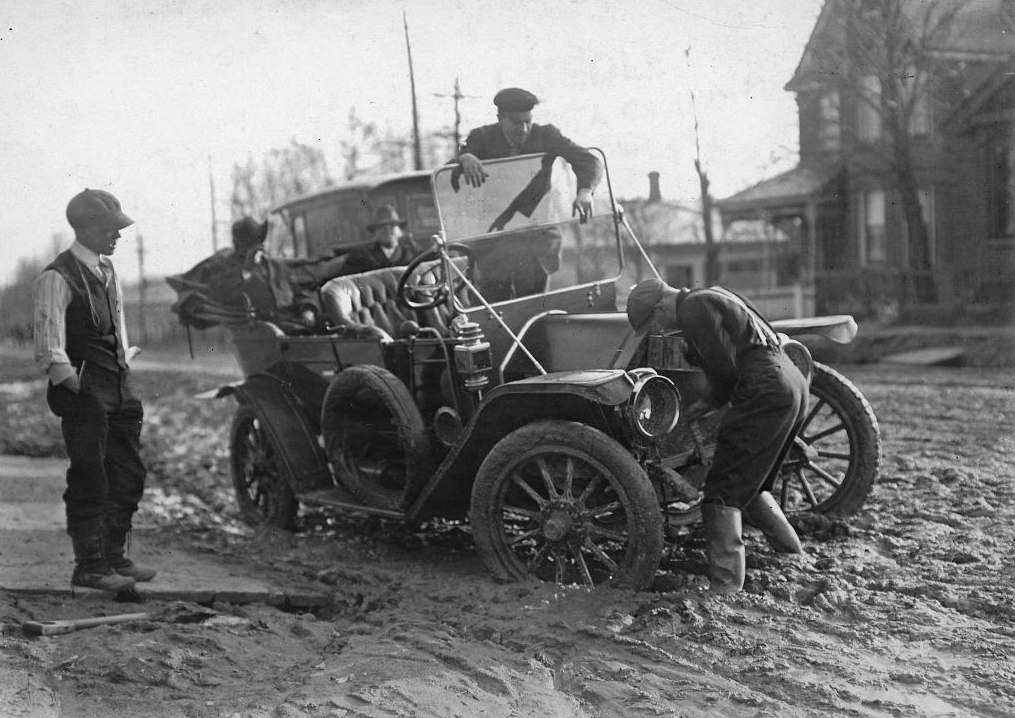 Paved roadways were constructed to allow vehicles to travel with ease. Before this, however, cars would often get stuck or break down in the muddy, unpaved streets, like this one in Toronto in 1913. City of Toronto Archives, fonds 1244 item 42.