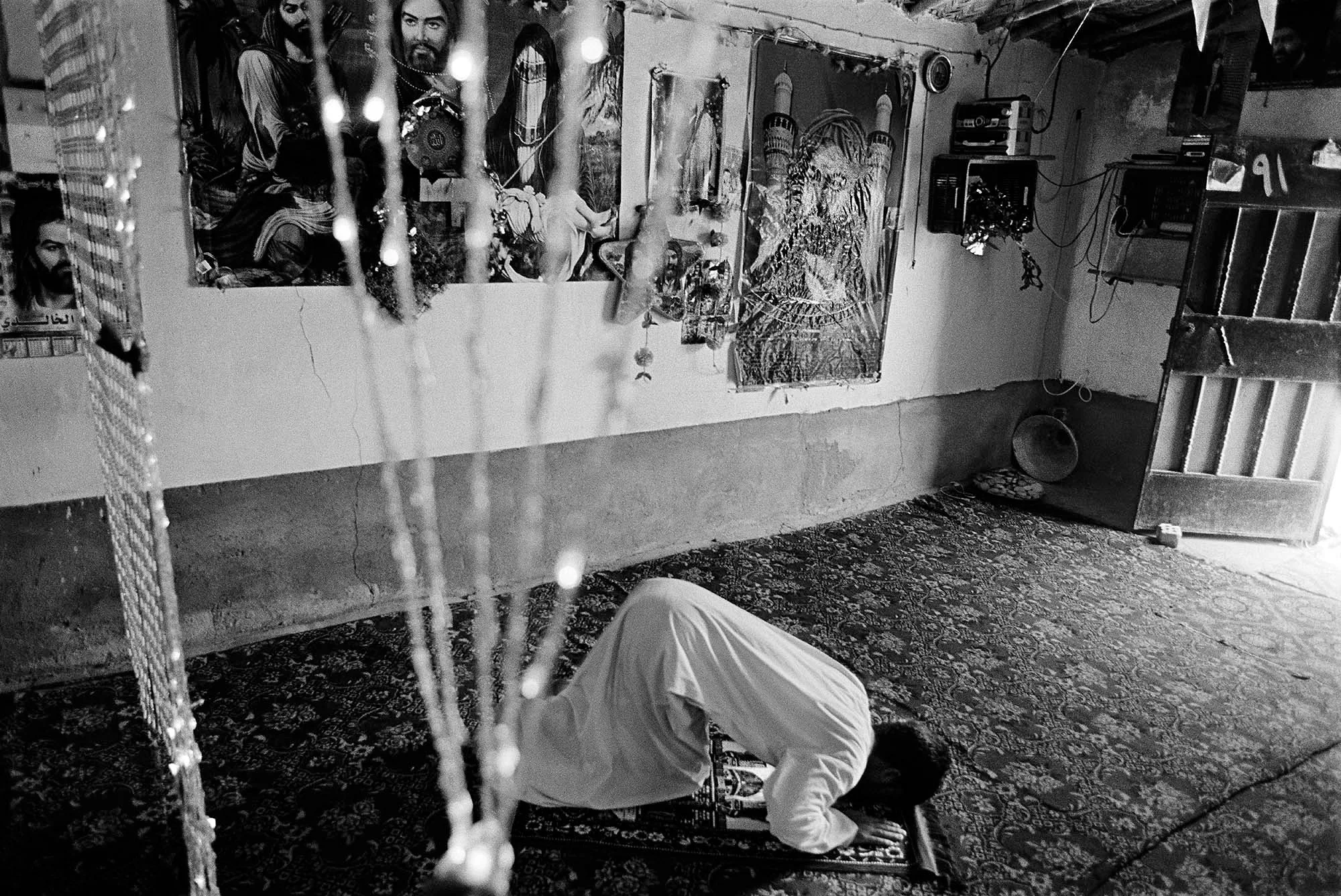 One hundred and twenty Dom families live in the Dom village of Al-Zuhoor, an isolated settlement outside of Diwaniyah. A young man from prays at the community mosque in a Dom settlement outside of Diwaniyah.