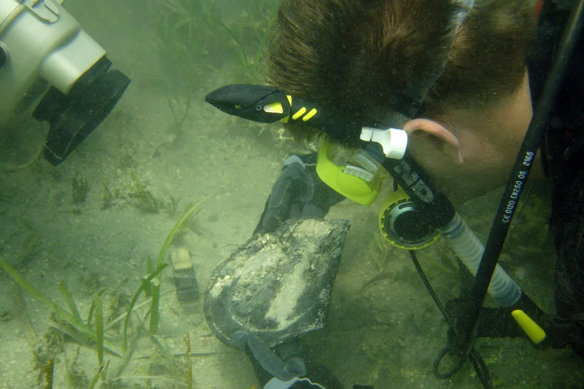 Dr. Spooner uncovering a pewter plate on The Tile Wreck