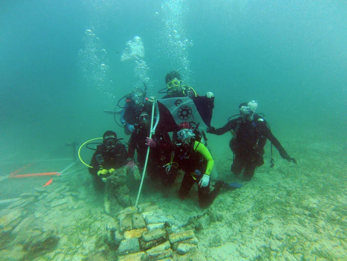 The Team flying The Explorer Flag on Le Casimir Wreck site.
