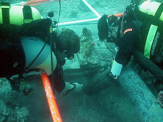 Dr. Spooner leading the excavation below the keel where the remains of a barrel of silver coins were found