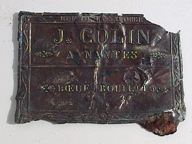  One of the first diagnostic artefacts, a copper alloy label from a tin, confirming that the tin was made from J Colin rue de la Salgorge from Nantes, France &nbsp; 