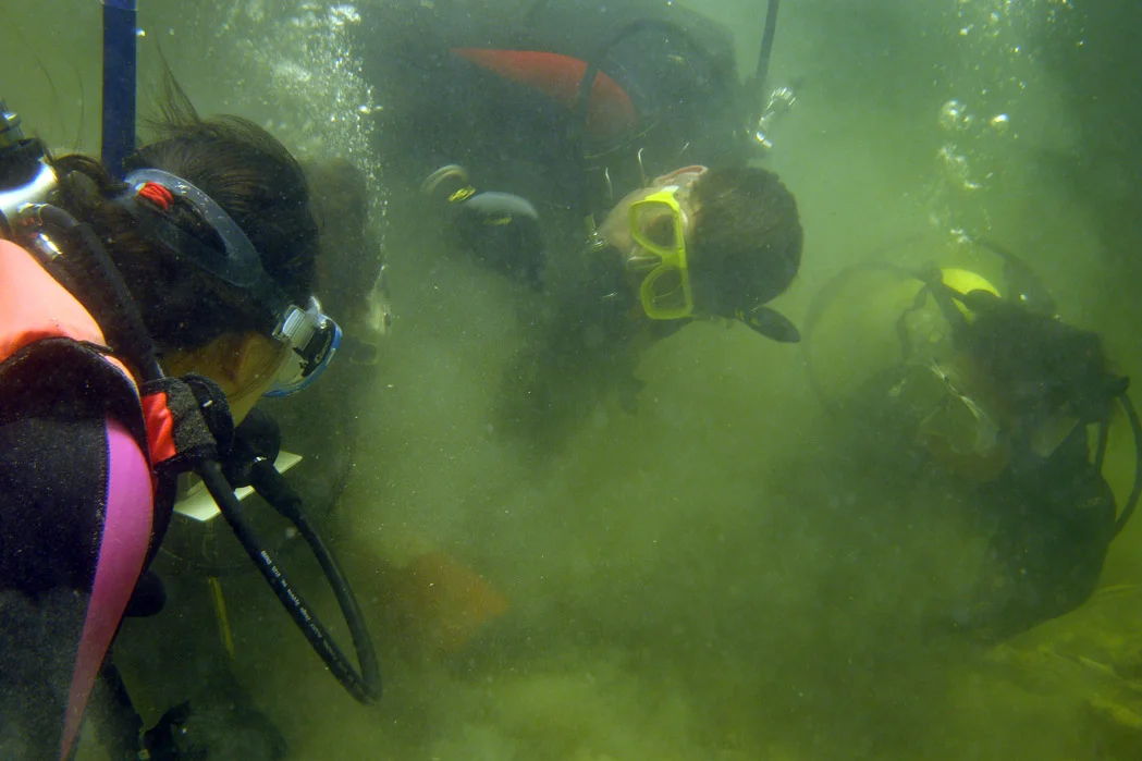 Dr. Chow (left) and Dr. Spooner (centre) training students on The Tile Wreck