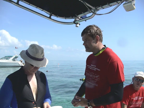 Dr. Spooner, having just surfaced from working on the wreck site, being interviewed by reporters on the success and importance of the project and the protection of the Cultural Heritage in the Florida National Keys Marine Sanctuary