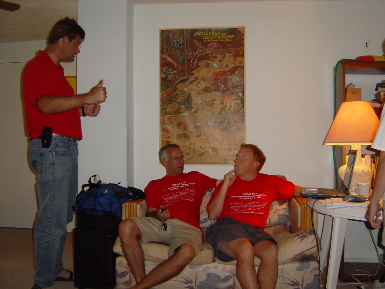 Simon informs Andy Shrimption and Guillaume that the grid is now ready to assemble in the garden