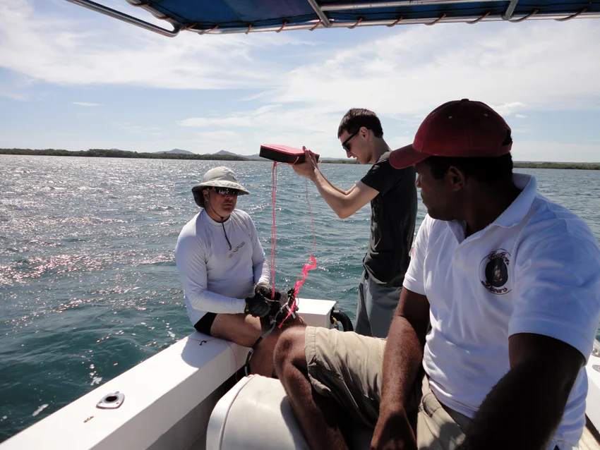 Boat Captain Robinson watches as Raimund and Ben attacha float to the AX2000 toridal magnetometer