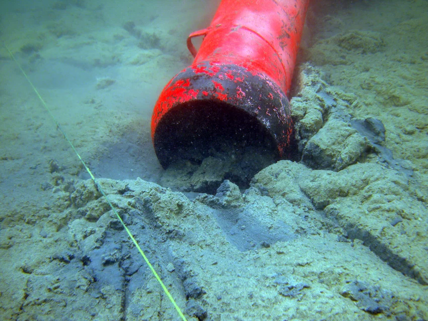The archaeological water dredge waiting to start, as it removed the thick mangrove mud, which covers the wreck site