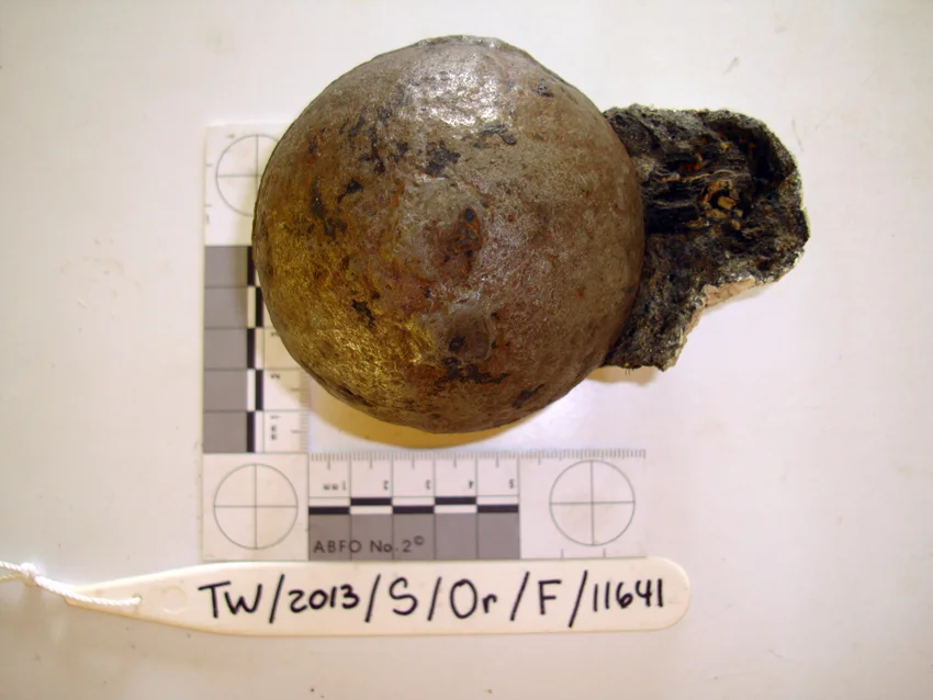 One of the grenades with the concretion removed showing the wooden fuse