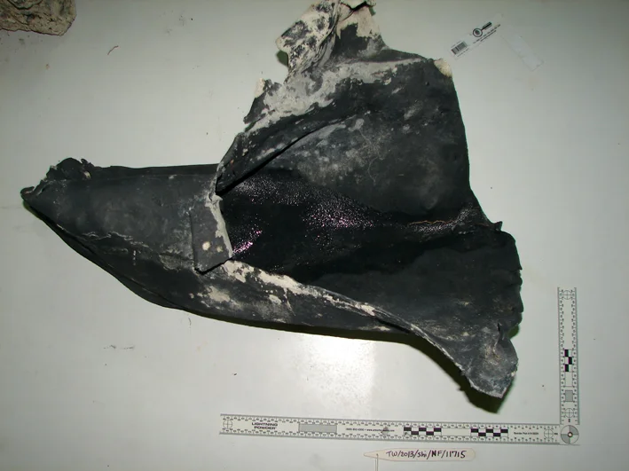 The lead object having a funnel shape with one end open and broken and the other constricted Originally we thought it was a hawser pipe which had been bent