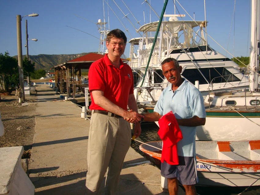 Dr. Spooner presenting Captain Tony Castillano with a limited-edition ADMAT Tile Wreck Project T shirt, for ADMAT's thanks to him for his assistance in the project