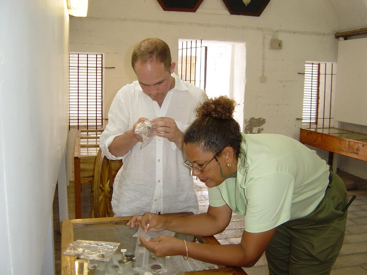 Capt. Amyas Godfrey and Hazel looking at buttons