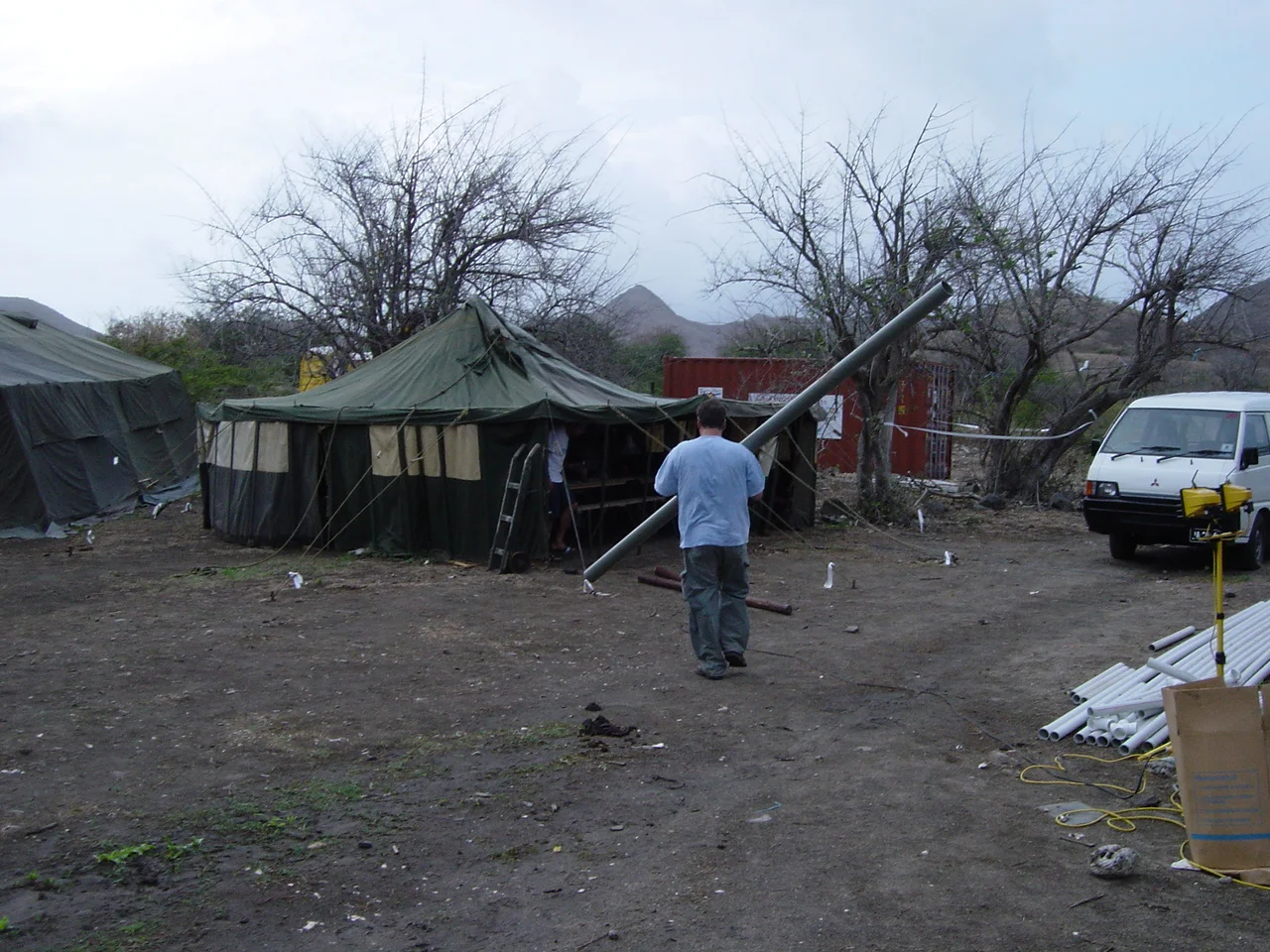 Louis fixing the broken tent pole with PVC piping provided by Polypipe