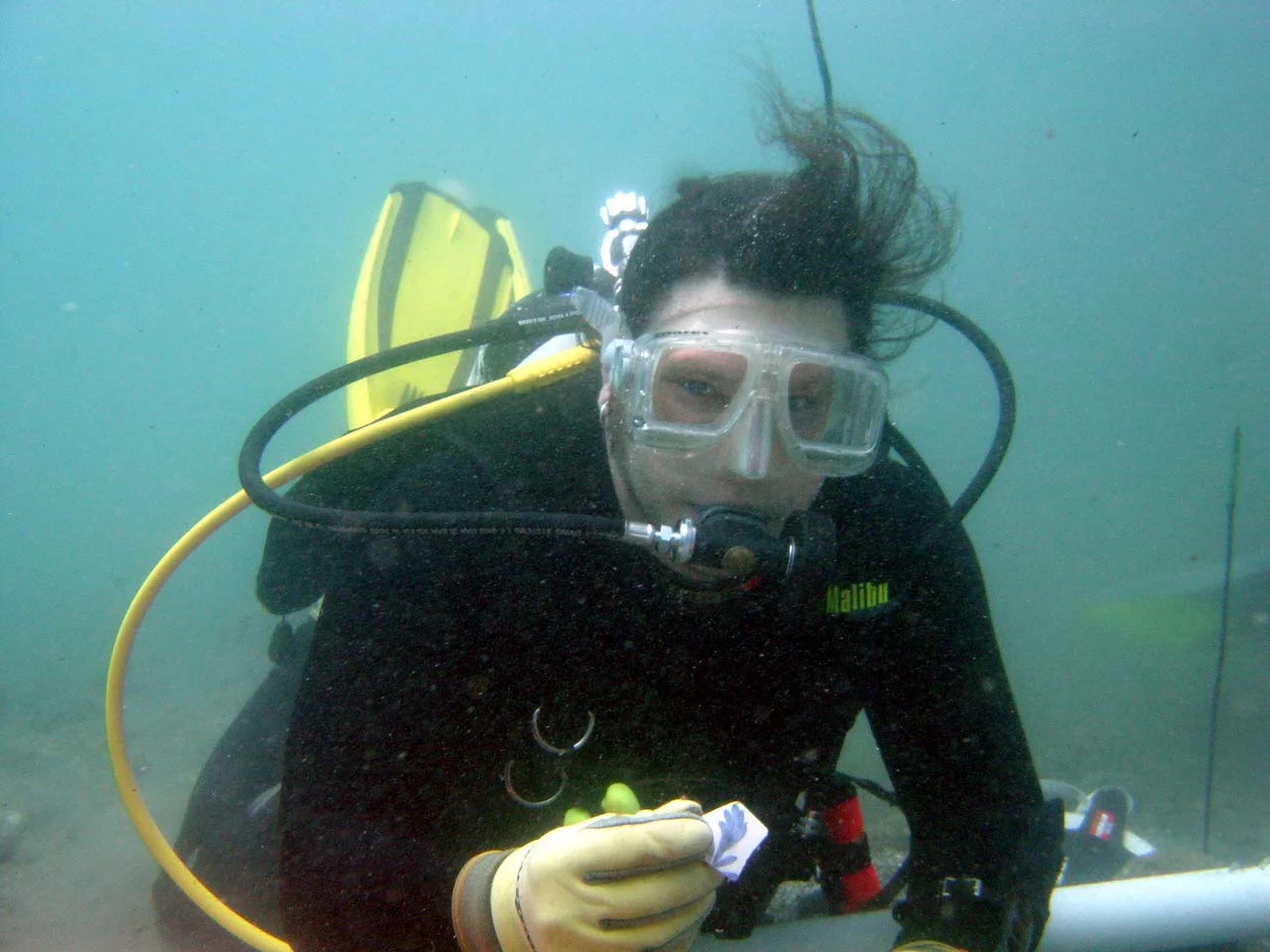 Matthew holding up a decorated pot sherd, his first artefact find on the wreck